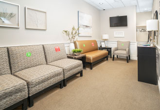 dental office waiting room with couches with social distancing markers